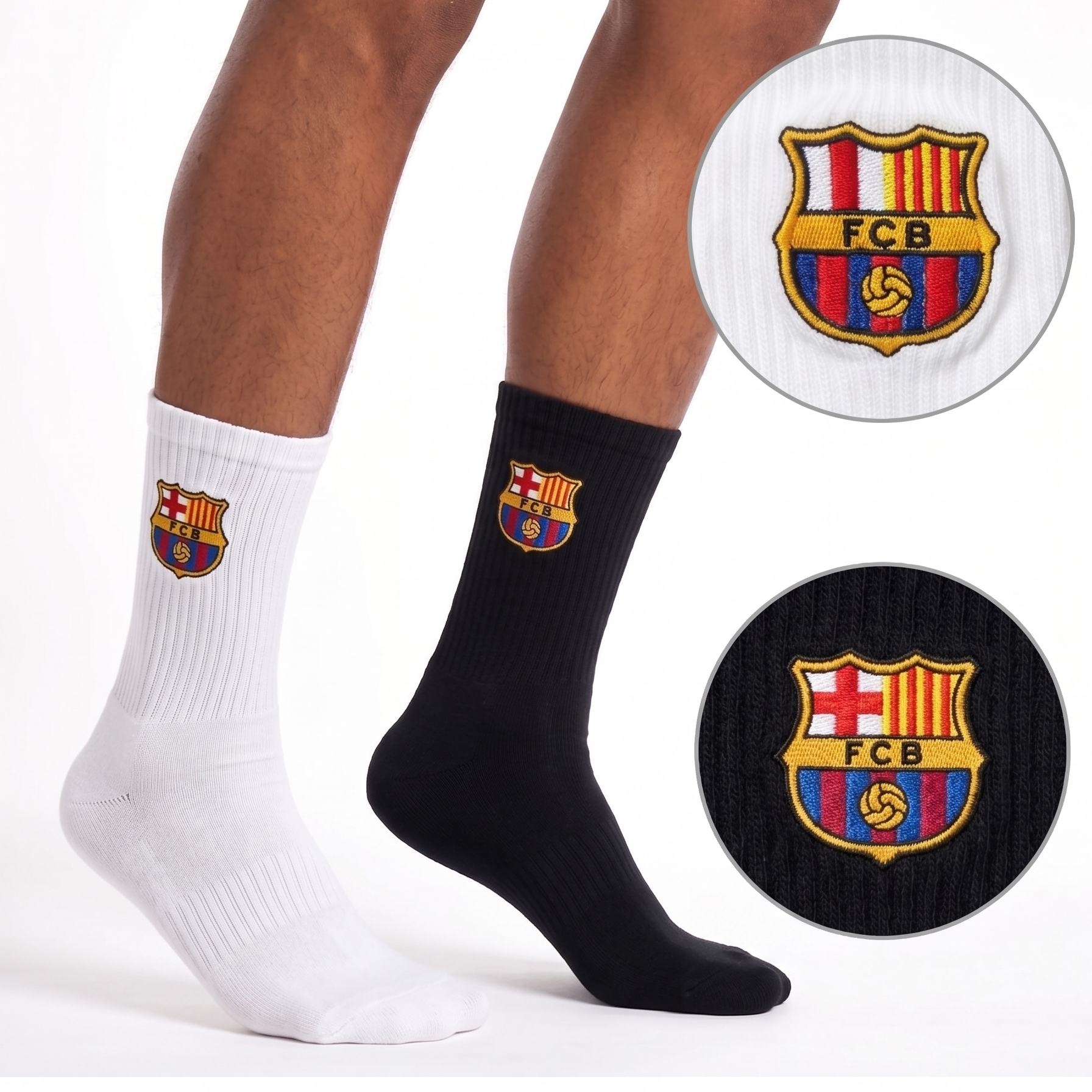 Two socks, one white and one black, with FC Barcelona logo on a white background.