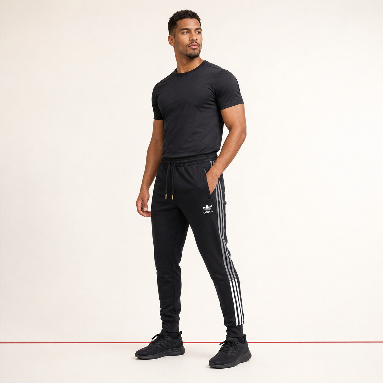 Male model wearing adidas black training sweatpants
