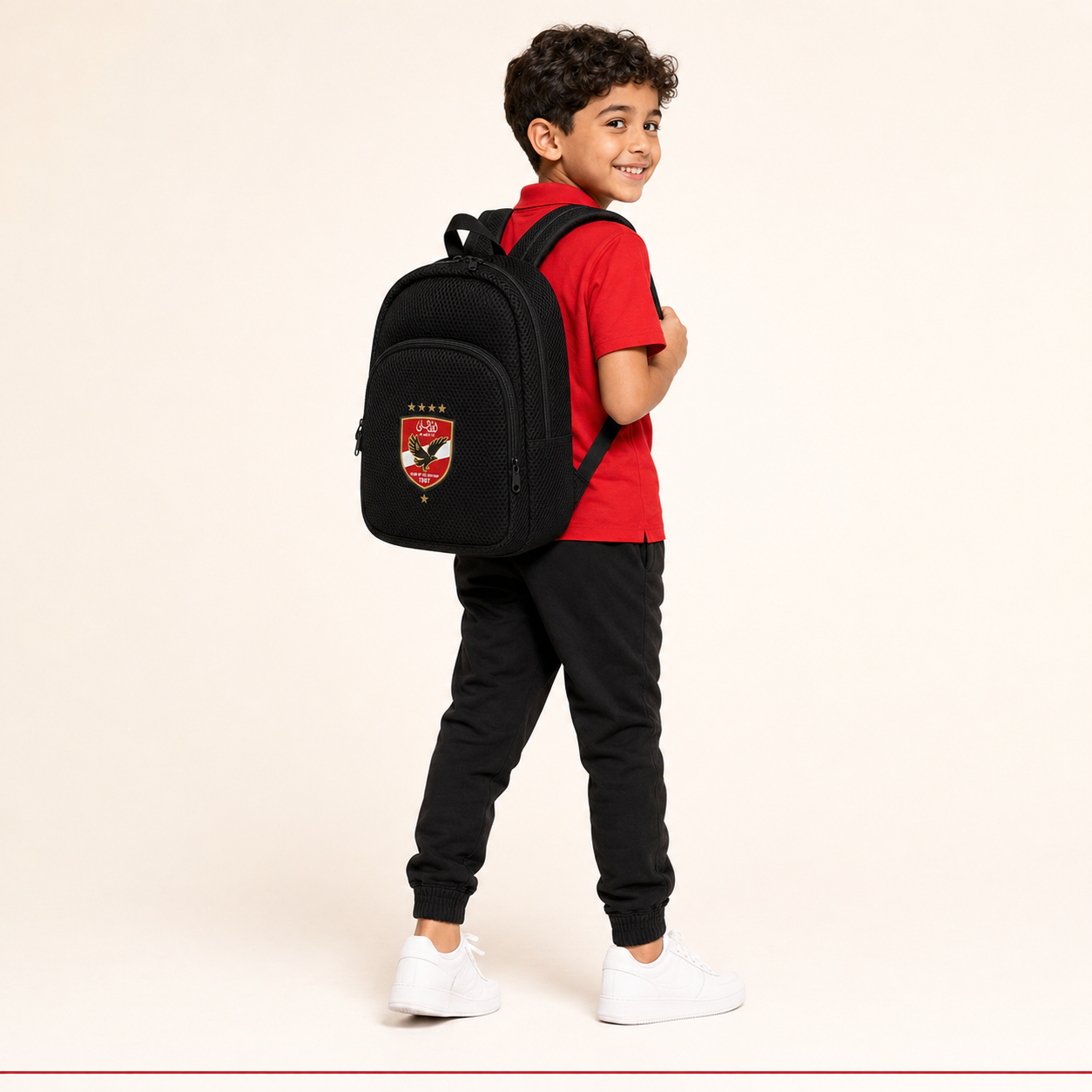 Child model wearing Al Ahly kids mini backpack