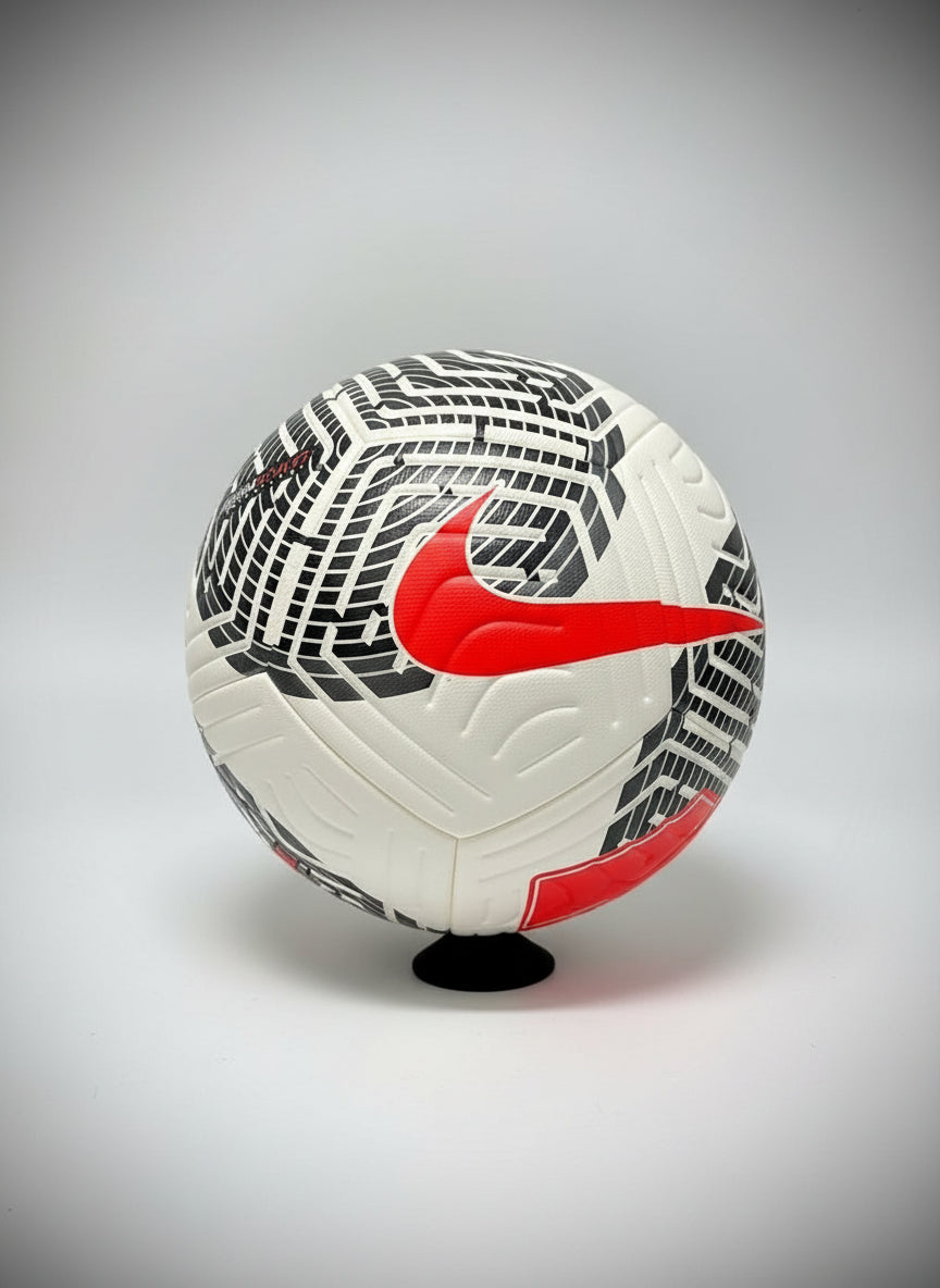 White soccer ball with red Nike logo on a black background